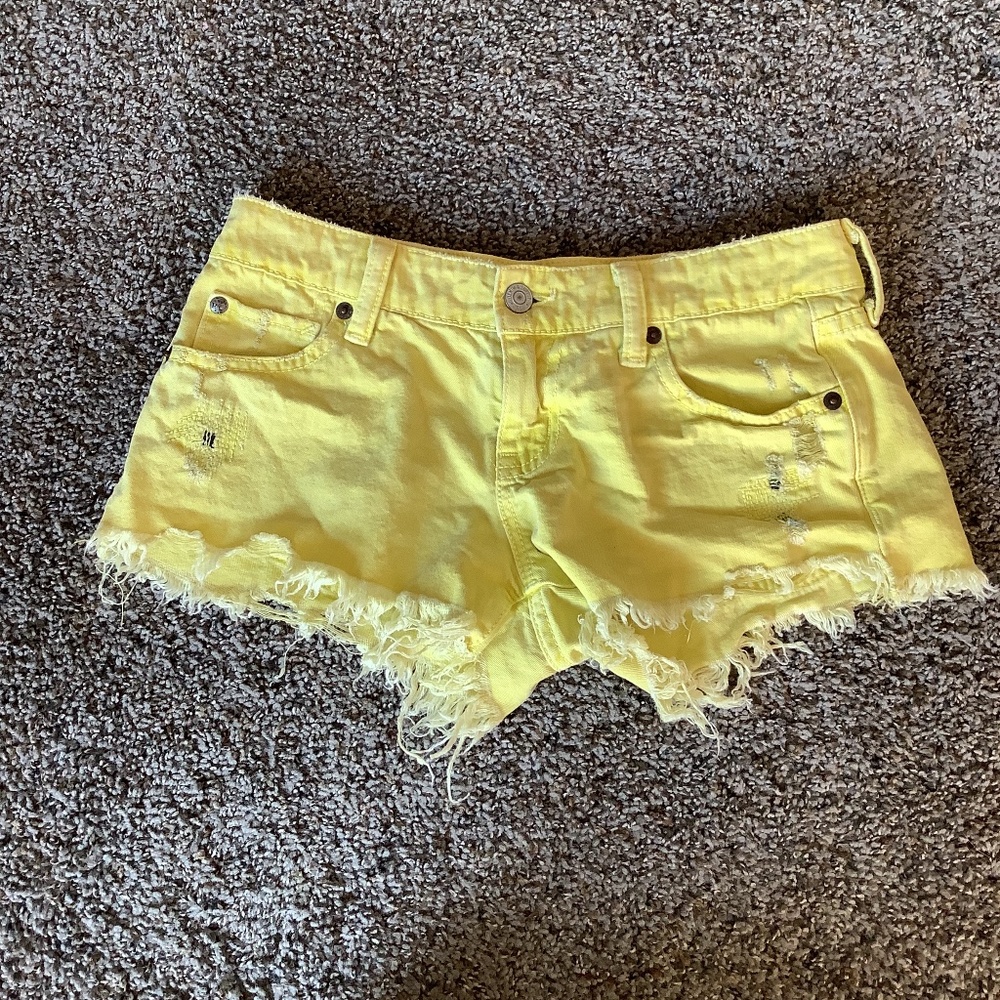 Yellow distressed shorts